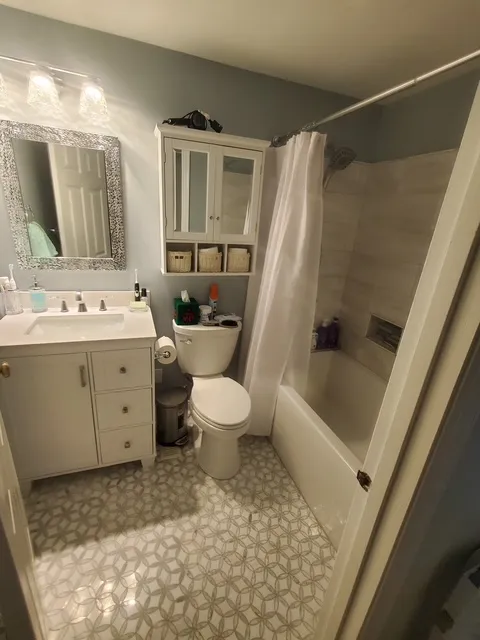 Bathroom vanity and mirror beside an alcove tub