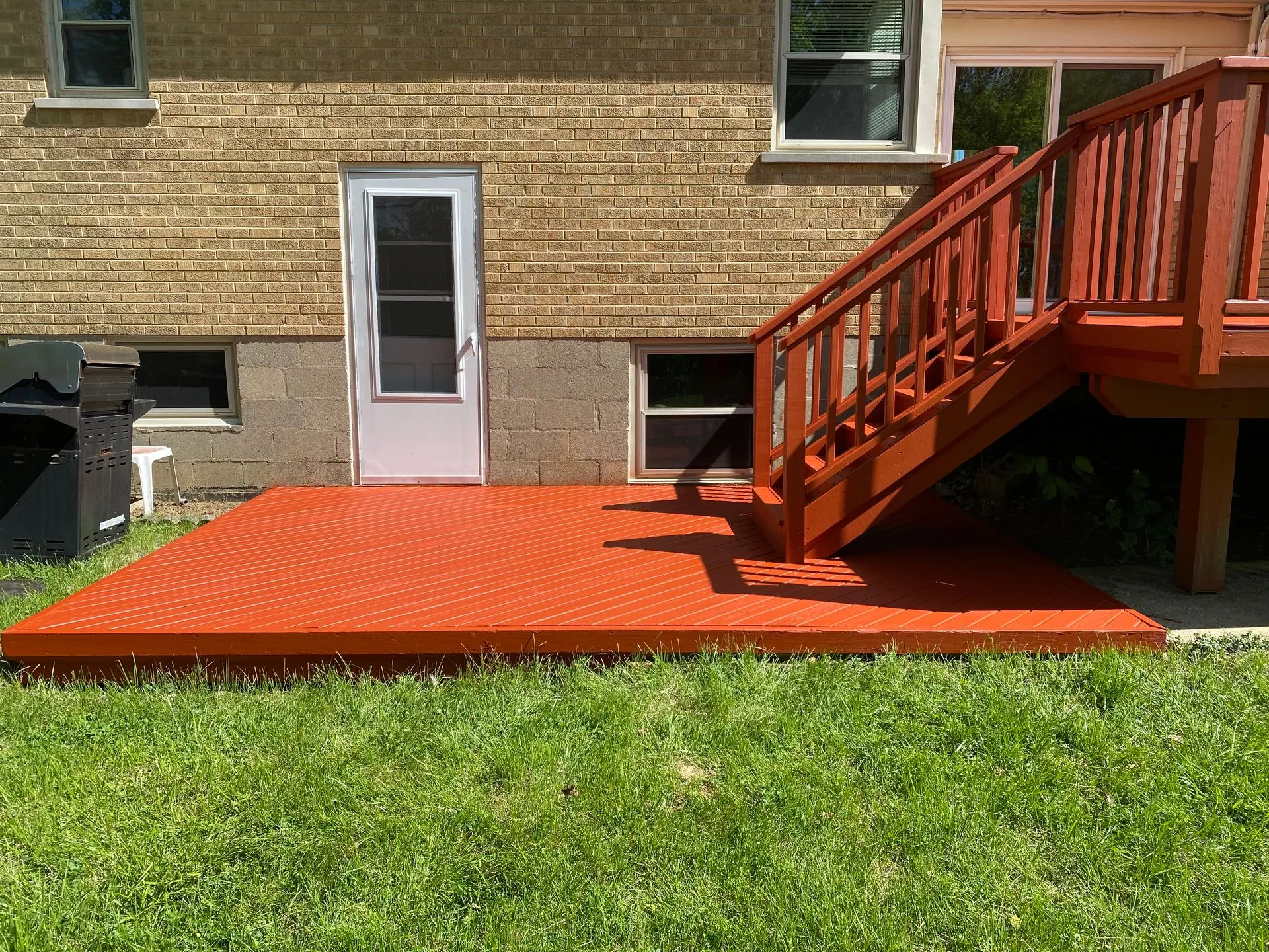 Ground level deck platform and stairs with fresh stain