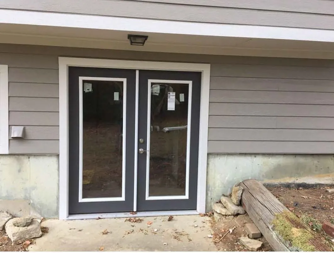 New charcoal french doors installed in a basement walkout