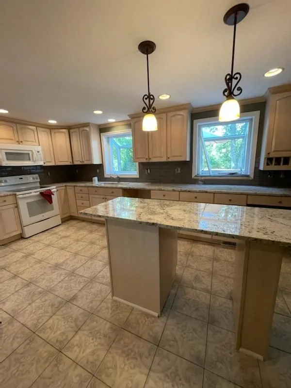 Kitchen remodel in progress with new granite counters and an island still under construction