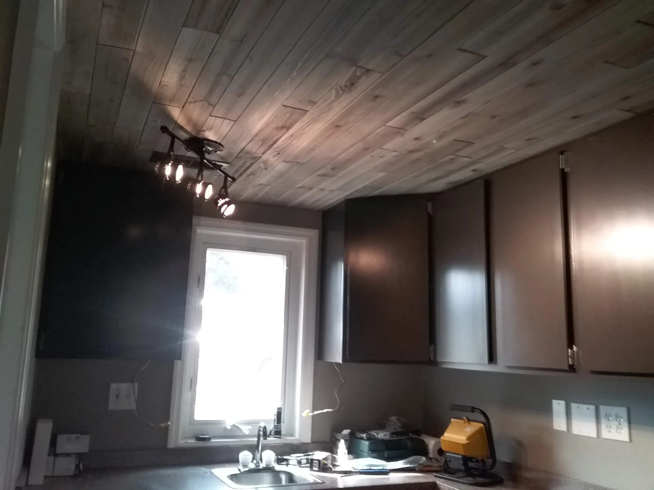 Kitchen remodeling in Hillsboro, OH — a reclaimed wood plank ceiling above dark stained cabinets