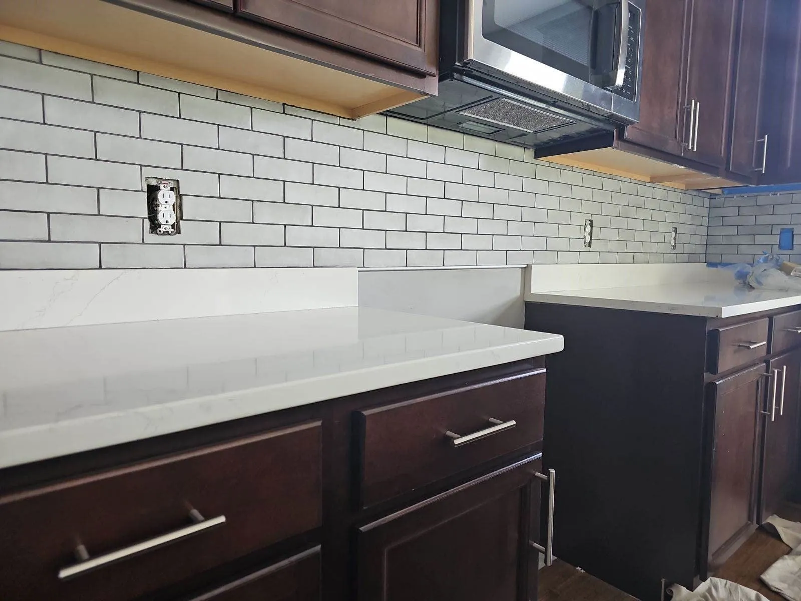 Kitchen remodeling near Cincinnati — white subway tile backsplash and quartz counters over espresso cabinets