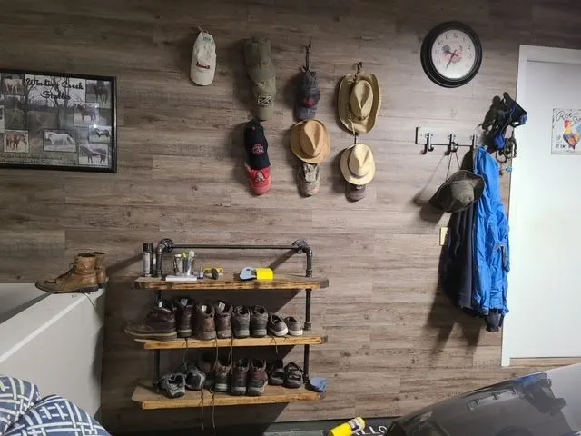 Custom mudroom shelving built from iron pipe and reclaimed wood